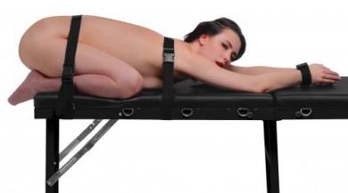 Bondage massage table with restraints
